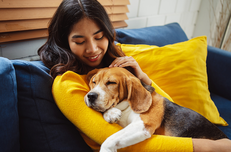 Woman cuddling a dog